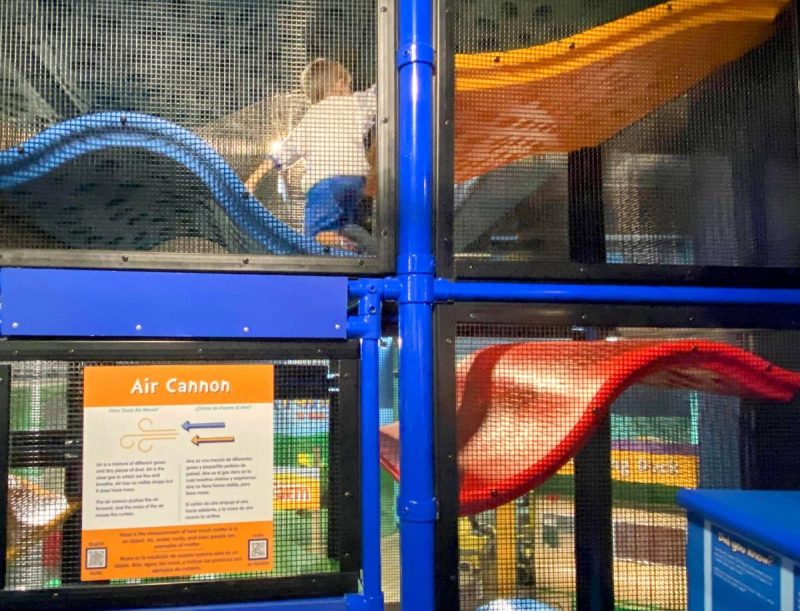 Young child climbing in the climber that goes from the first floor to the second floor at the Children's Museum of Atlanta