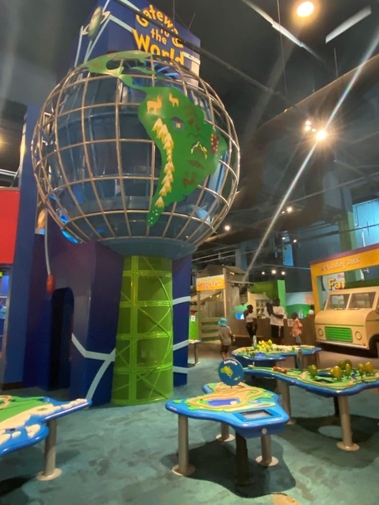 Gatweay to the World Globe with continent tables in the foreground, the newest permanent exhibit at the Children's Museum of Atlanta.