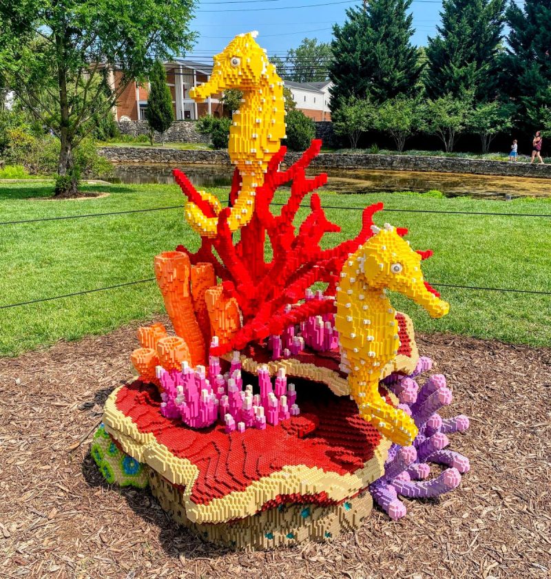 Two sea horses on a bed of coral made of thousands of bright colored LEGO pieces