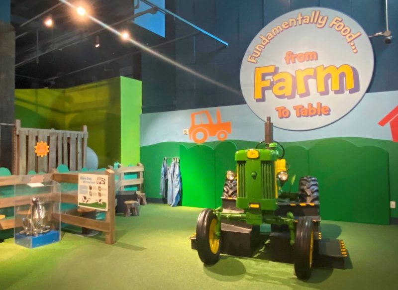 John Deere tractor for kids to climb on at the farm in the Fundamentally Food exhibit at the Children's Museum of Atlanta.