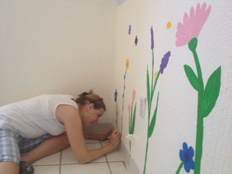 Painting a mural on a wall during a mission trip to Ciudad Juarez in Mexico.