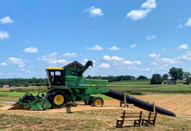 John Deere Combine turned into play structure and slide at West Oaks Farm Market in Winchester VA. Farm can be seen in background