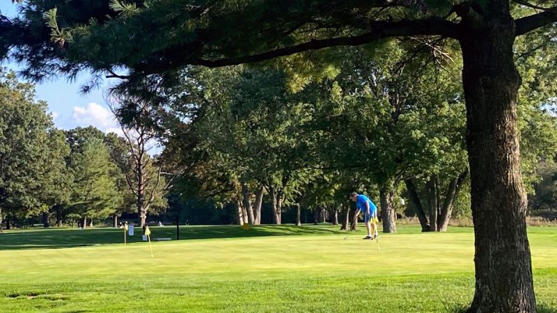 Man in blue shirt at the practice green at Algonkian Regional Park in Loudoun County, VA