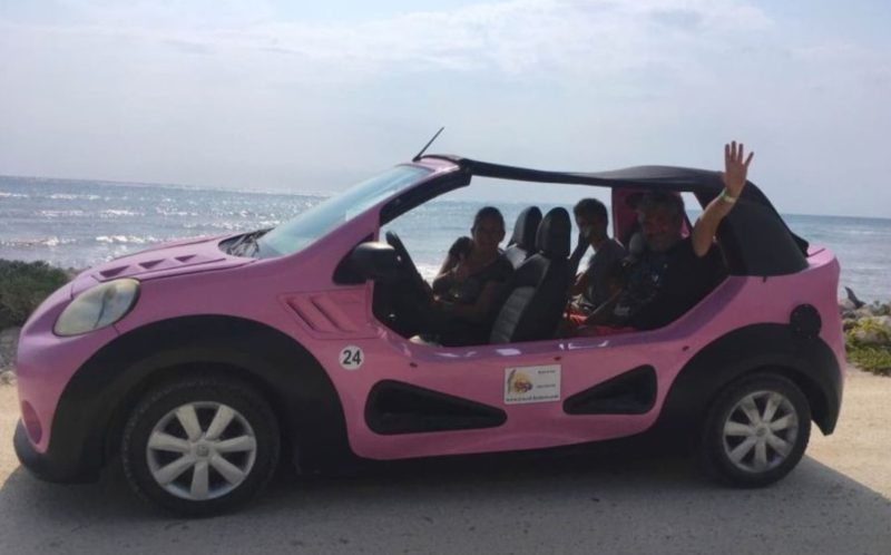 Pink buggy with sun shade at the beach in Cozumel