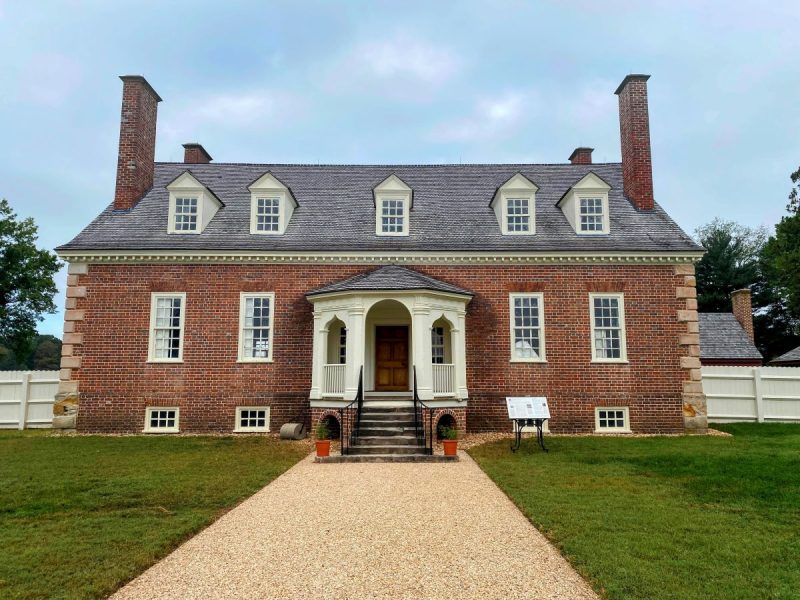 Front facade of Gunston Hall in Fairfax County, VA. A stately, three story Georgian structure made of red brick, with symmetrical chimneys, windows and a center hall.