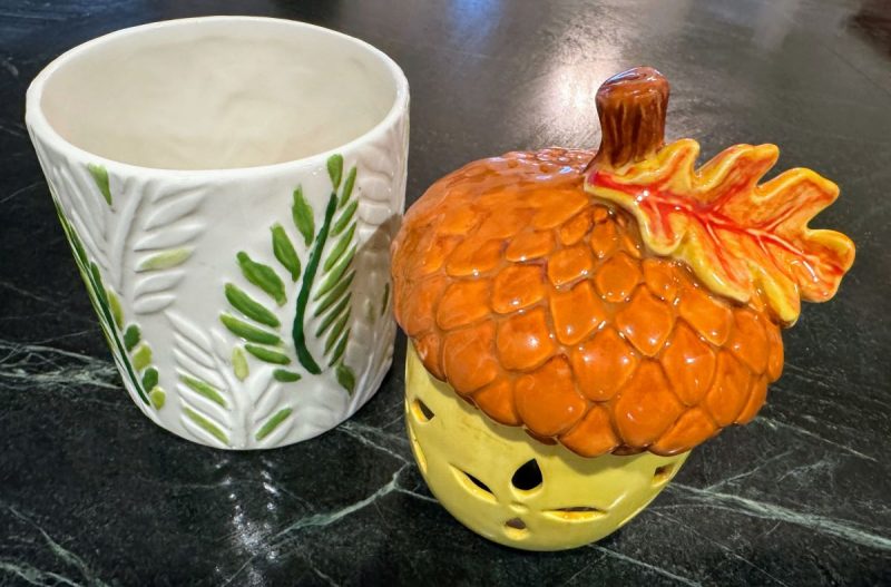 Glazed paint your own pottery from Earth Glaze & Fire in Warrenton, VA. Left is a white planter with some leaves painted green. Right is an acorn in shades of brown, orange and yellow with a yellow and red oak leaf