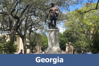 Statue on pedestal with live oak trees in Savannah Georgia