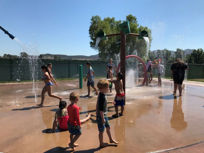 Kids playing at the splash pad at Santee Lakes, one of the best campgrounds for families in California
