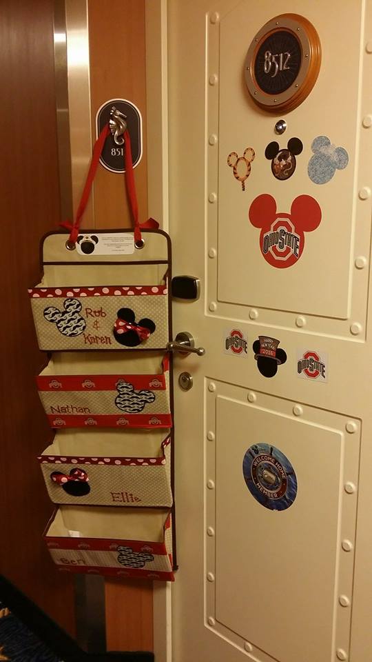 Fish extender hanging from our fish mailhook on the Disney Dream, and to the left a door decorated in fun magnets for the cruise.
