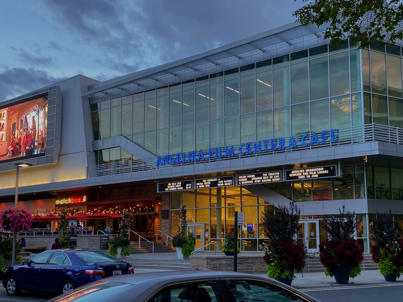 Exterior of the Angelika Film Center showing movie on the outdoor screen in the Mosaic District Fairfax VA.