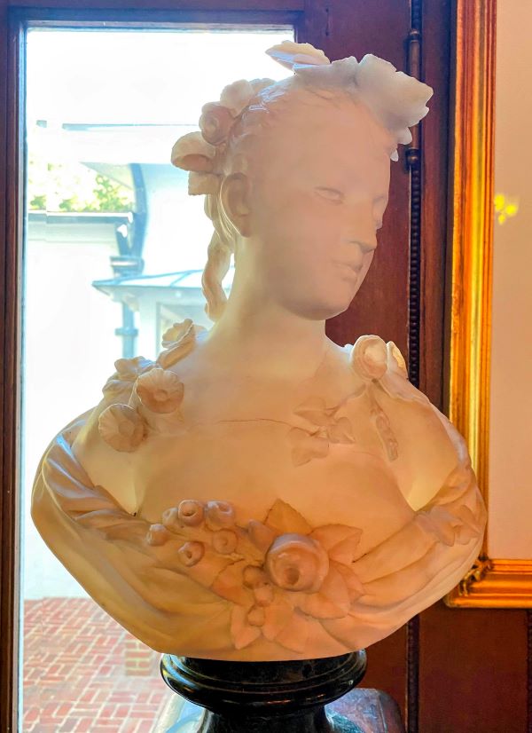 Bust statue of a woman in elegant dress on display at Morven Mansion.