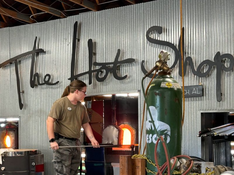 Staff demonstrating how to make blown glass at the Hot Shop in Alabama.