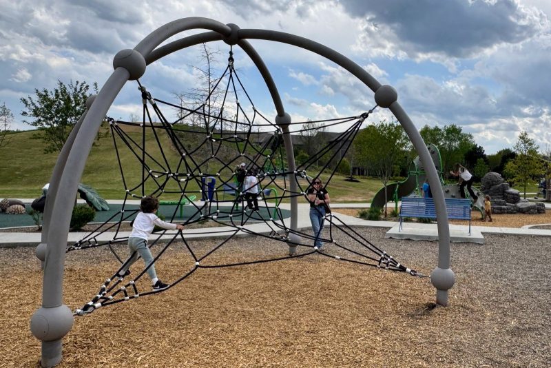 Playground at Little Debbie Park with kids on climbing equipment.