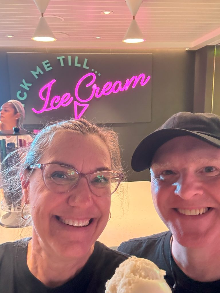 Two people taking selfie with ice cream cone at "Lick Me till Ice Cream."