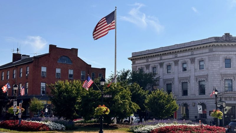 Carlisle Street in Downtown Gettysburg, PA with American flag on flagpole in center.