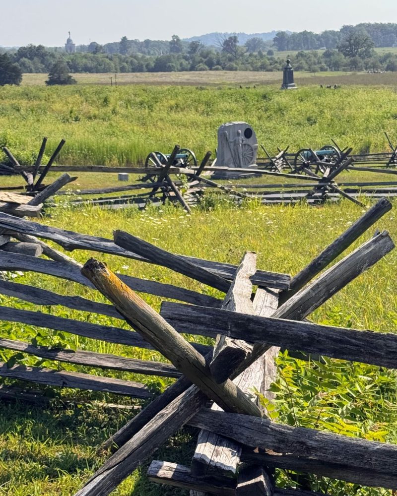 Gettysburg Battlefield today, monuments, split rail fence and grassy fields.