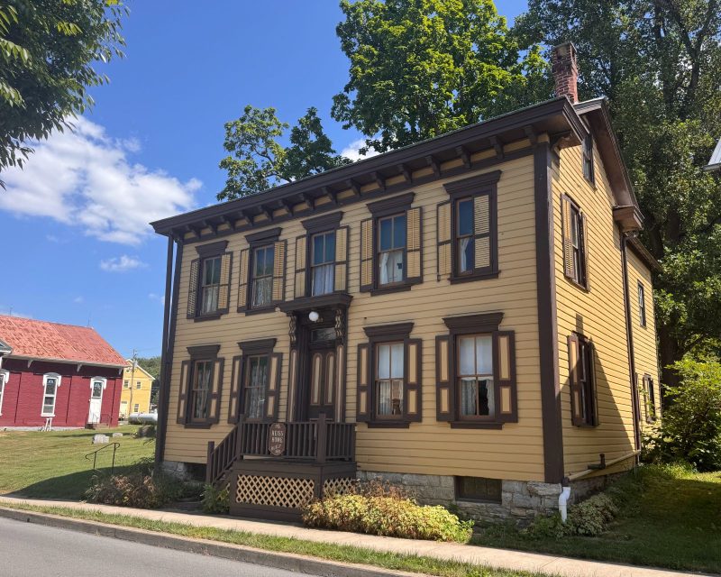 Historic home painted yellow with brown trim in the Susquehanna River Valley.