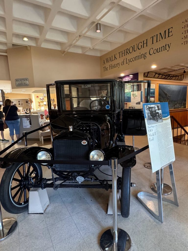 A Walk Through Time Gallery at Taber Museum with old time car at front.